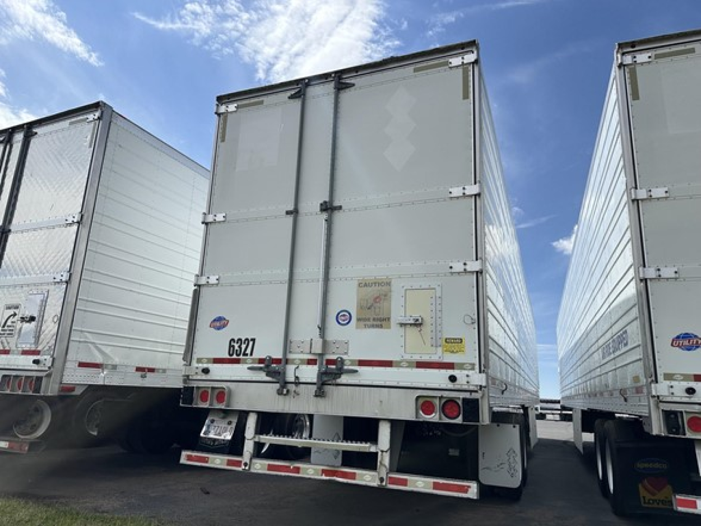 Rear view of a 2015 Utility 3000R trailer showing doors, bumper step, and taillights.
