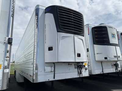 Trailer refrigeration unit on 2015 Utility 3000R reefer trailer, front view with cooling unit, side loading doors, adjacent unit, clear sky
