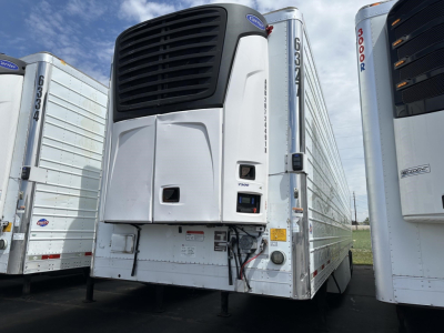Trailer refrigeration unit on a 2015 Utility 3000R refrigerated trailer showing Thermo King or similar unit mounted at front with black grille and control panel, side doors, and white body.