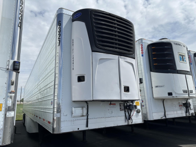 Utility 3000R trailer with Reefer unit showing front refrigeration unit and side panel, white with black front grill, parked among similar trailers.