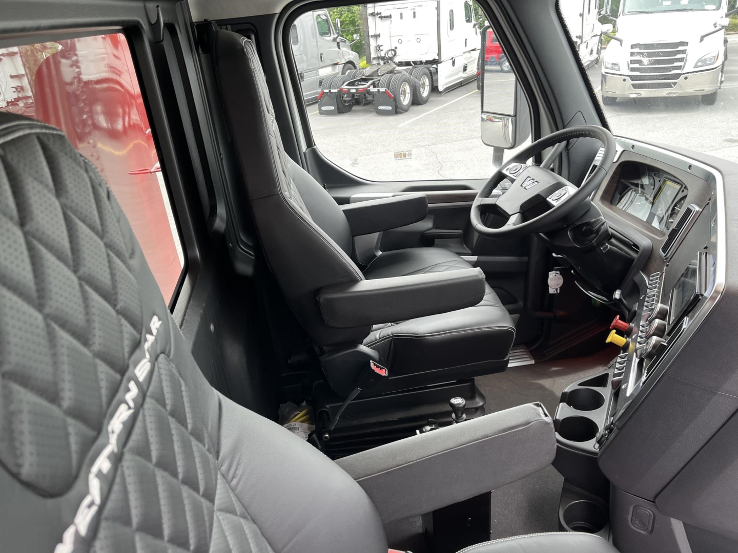 Western Star 47X truck cab interior showing driver's seat and dashboard with steering wheel and control area.
