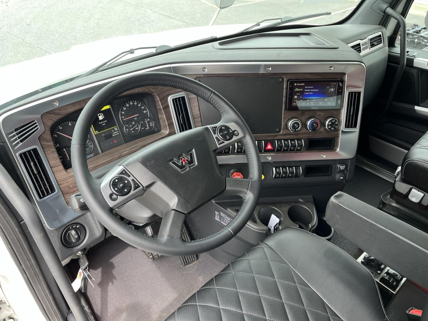 Western Star 47X cab interior showing steering wheel, dashboard, and touchscreen infotainment system.