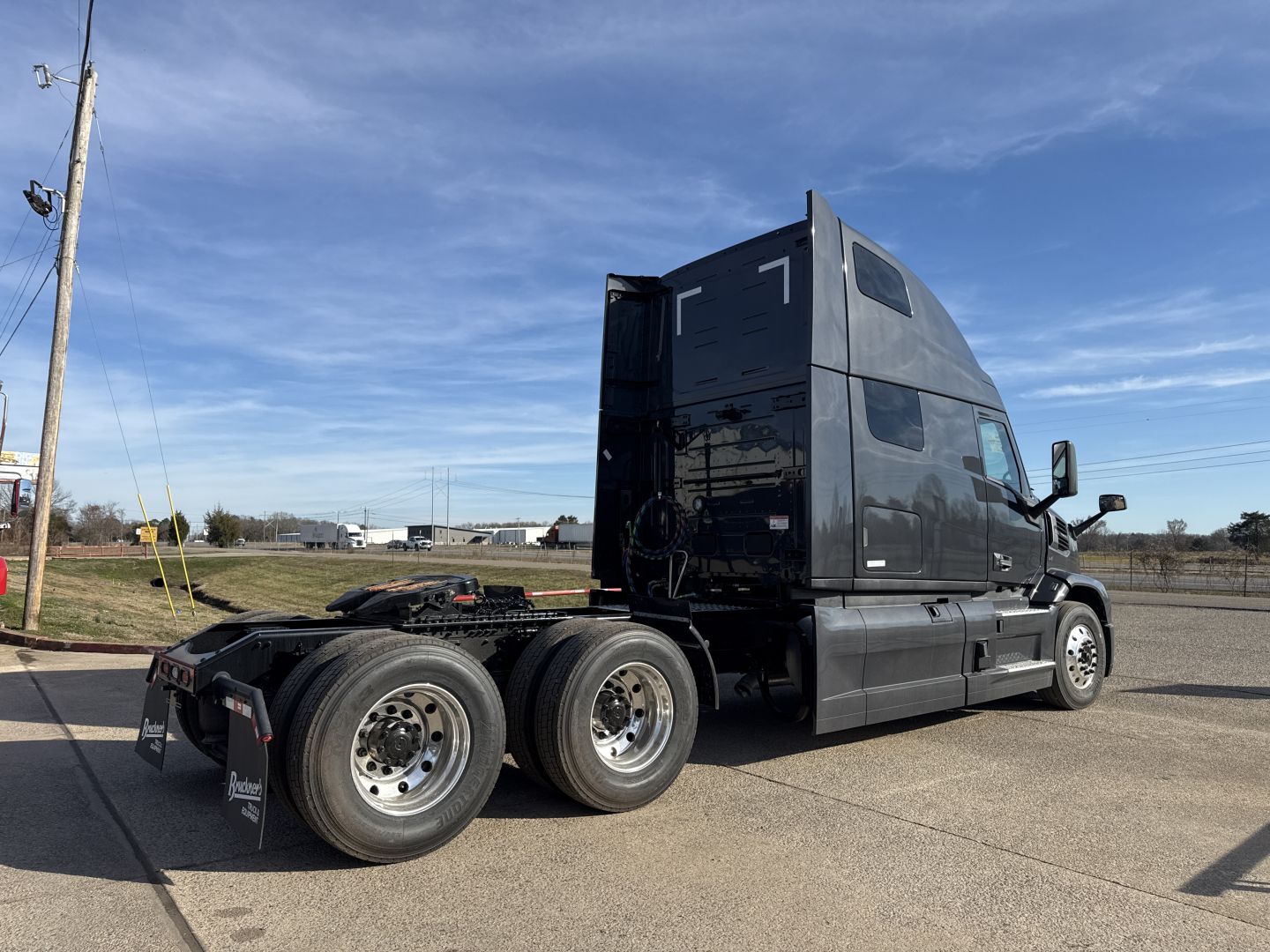 Truck cab and chassis of a new Mack PR64T76H conventional sleeper with dual rear axles, black paint, VIN 1M1PR4GY4TM101031 visible on listing page.
