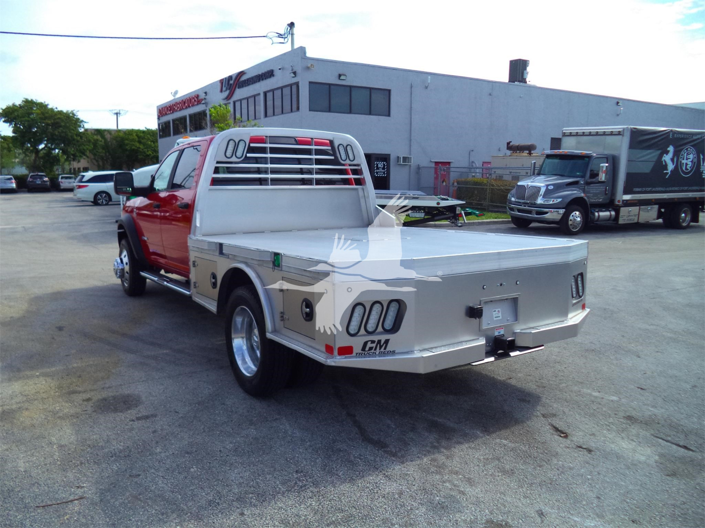 2024 Ram 5500 SLT flatbed truck rear/side view showing flatbed toolbox and tail lights.