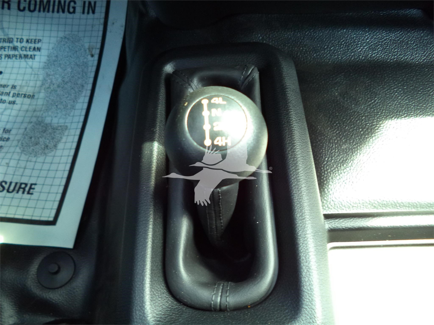 Knob showing transfer case shift with 4L/4H markings inside Ram 5500 truck cab.