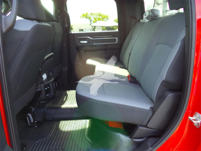 Ram 5500 interior showing front bench seats and back seat, grey upholstery, door panel, and floor mats.