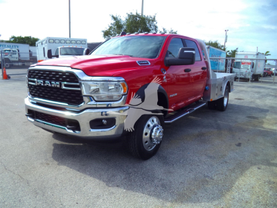 Ram 5500 SLT flatbed truck in red front three-quarter view showing chrome grille and dual rear wheel on flatbed.