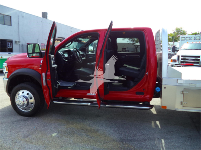 Ram 5500 SLT truck side view with front and rear doors open showing interior cabin and steps, red exterior, flatbed rear with chrome wheel well, stock number RAM5500LALSKCM.