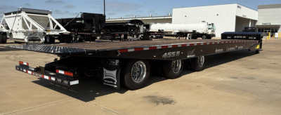 Lowboy trailer showing 455B-53 55-ton traveling axle with flatbed and multiple axles.