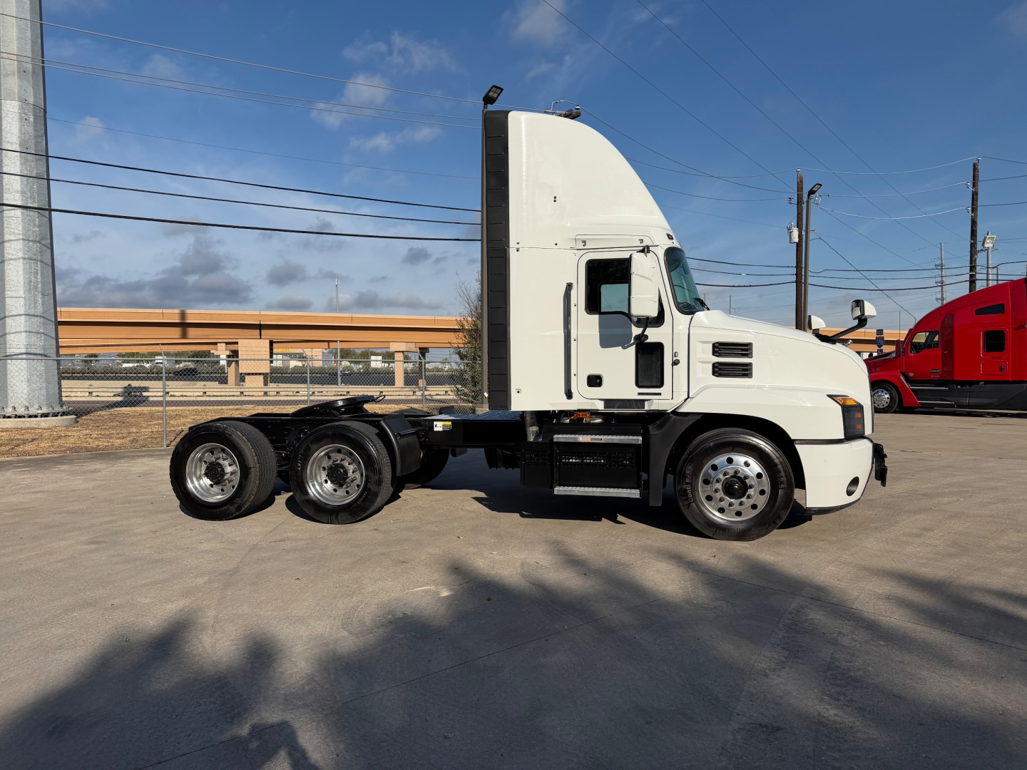 Mack ANTHEM 64T tractor truck side view showing cab and dual rear axles with white exterior.