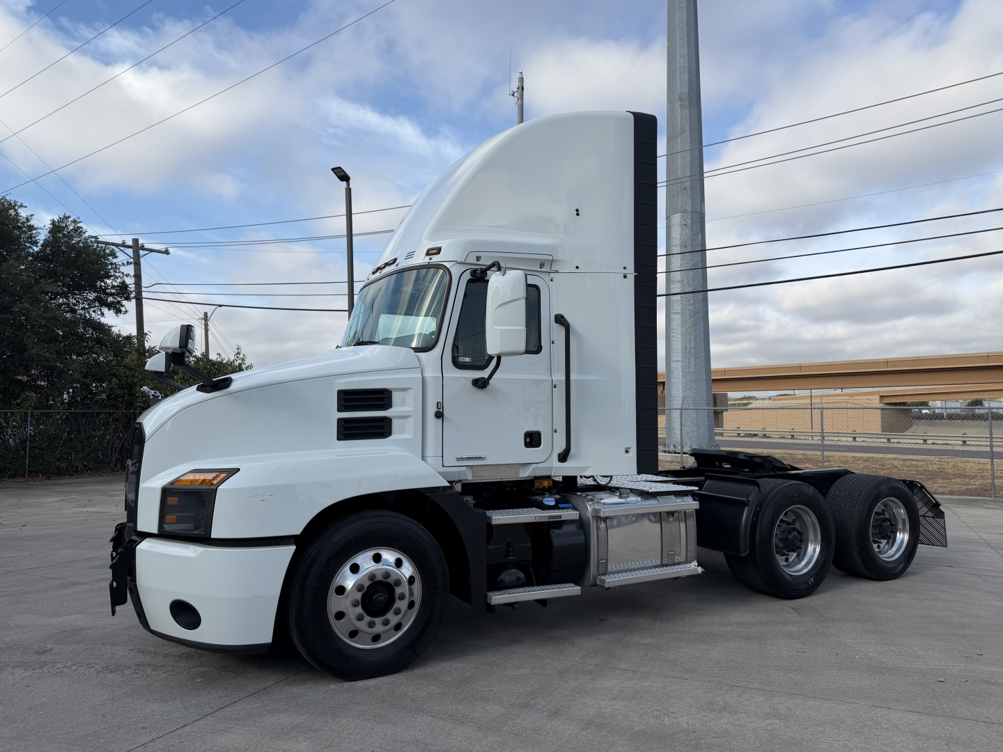 2023 Mack Anthem 64T side view showing sleeper cab, front bumper, wheels, and triple rear axles.