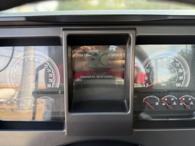 Dashboard view showing instrument cluster and center display of a Mack ANTHEM 64T truck; visible gauges and a digital odometer area.