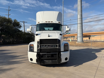 Truck front view showing Mack ANTHEM grill and bumper with white cab and elevated sleeper