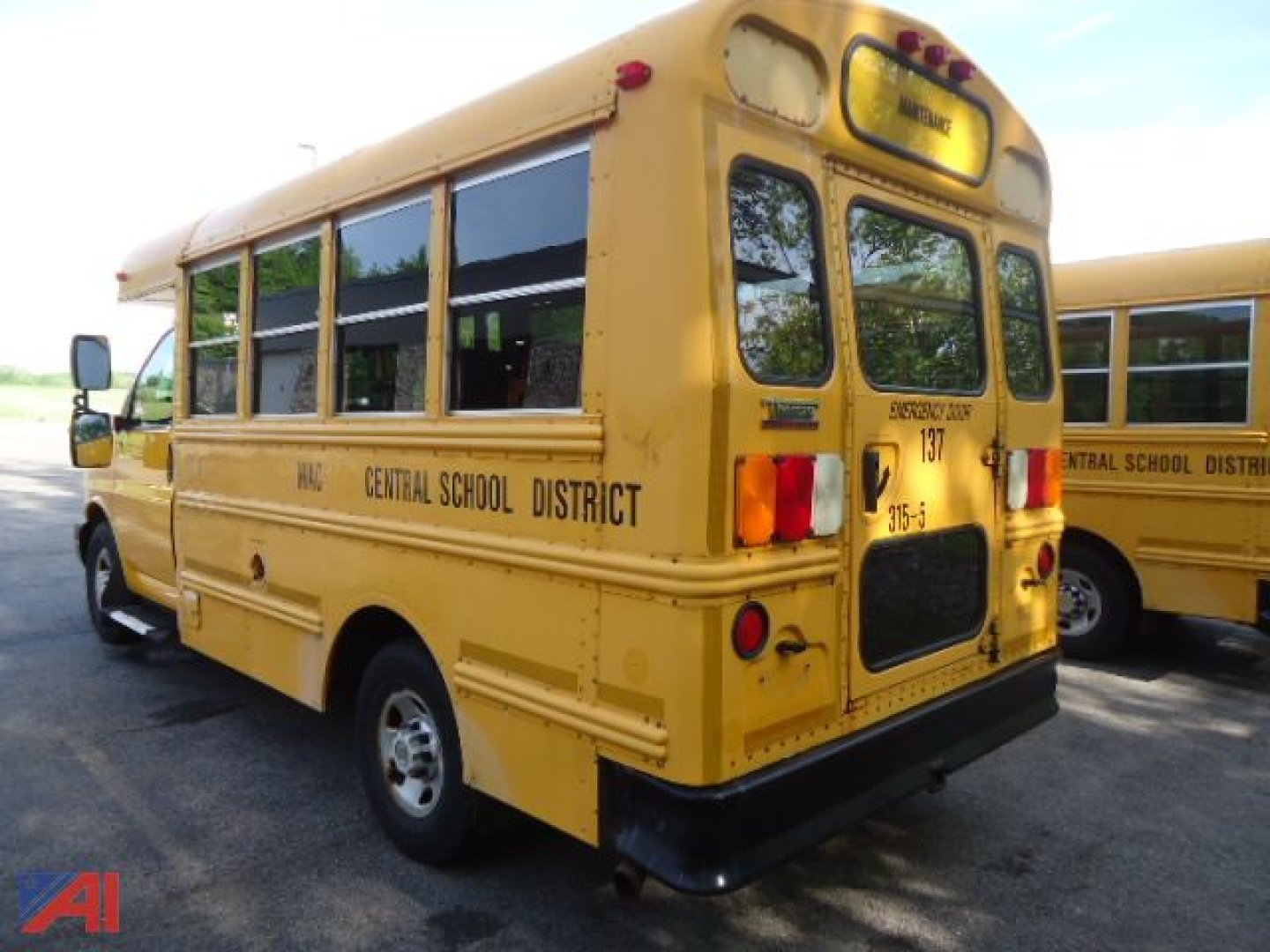 School bus showing rear and left side with Central School District text and yellow body, 2014 model, bus windows and rear bumper visible.