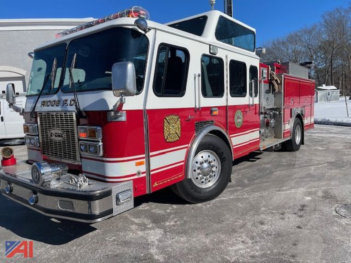 Emergency Response vehicle: 1992 Emergency One Cyclone Pumper fire truck, red and white, front grille with lights, side compartments, water pump gear visible.
