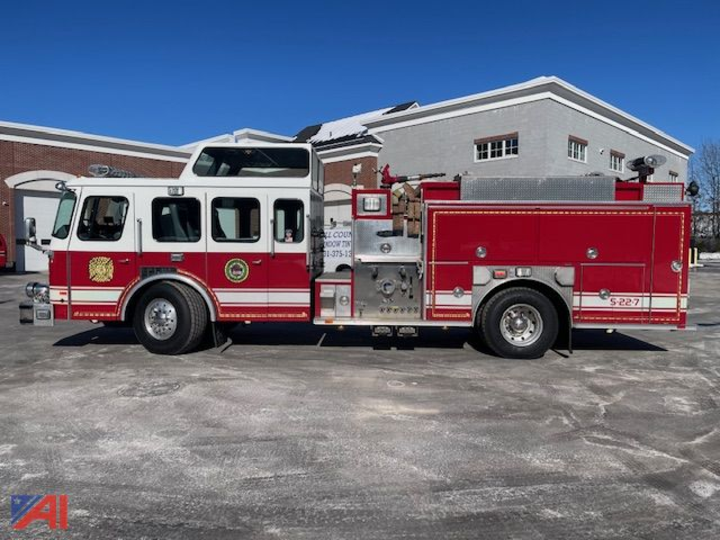 Emergency One cyclone pumper fire truck side view with red and white livery and equipment compartments