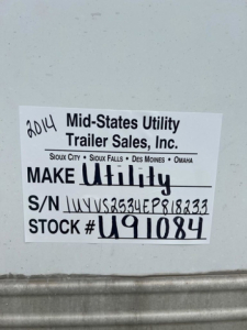 Label on van showing 2014 Mid-States Utility Trailer Sales stock tag with S/N and STOCK # U91084.