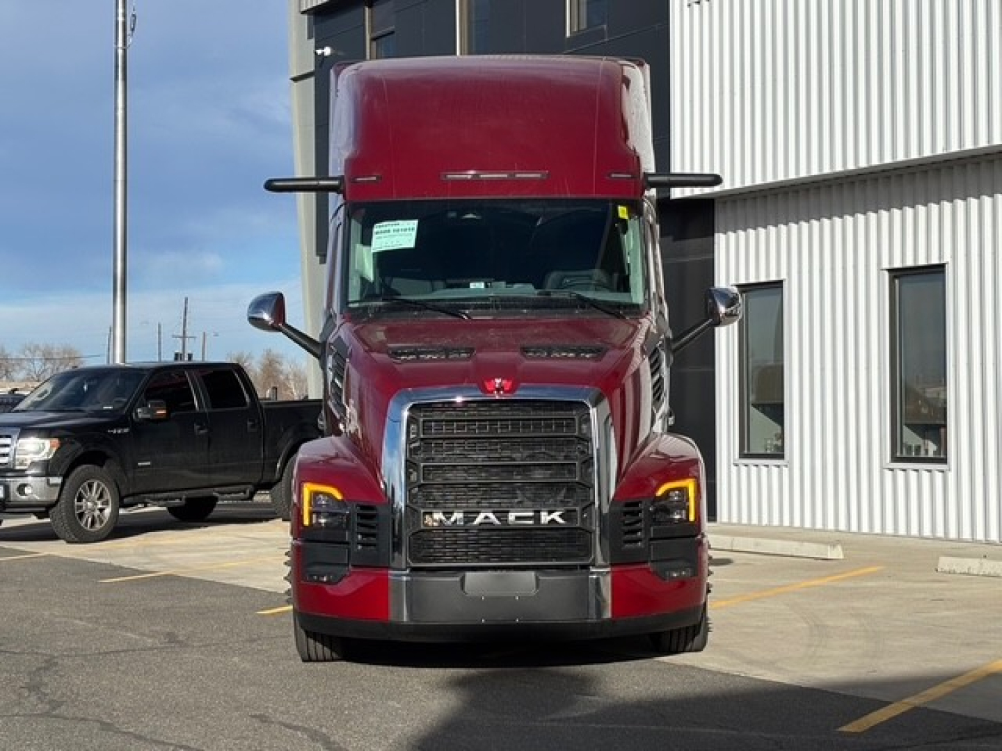 Mack PR64T76H conventional sleeper truck front view showing bold grille and red cab with elevated sleeper