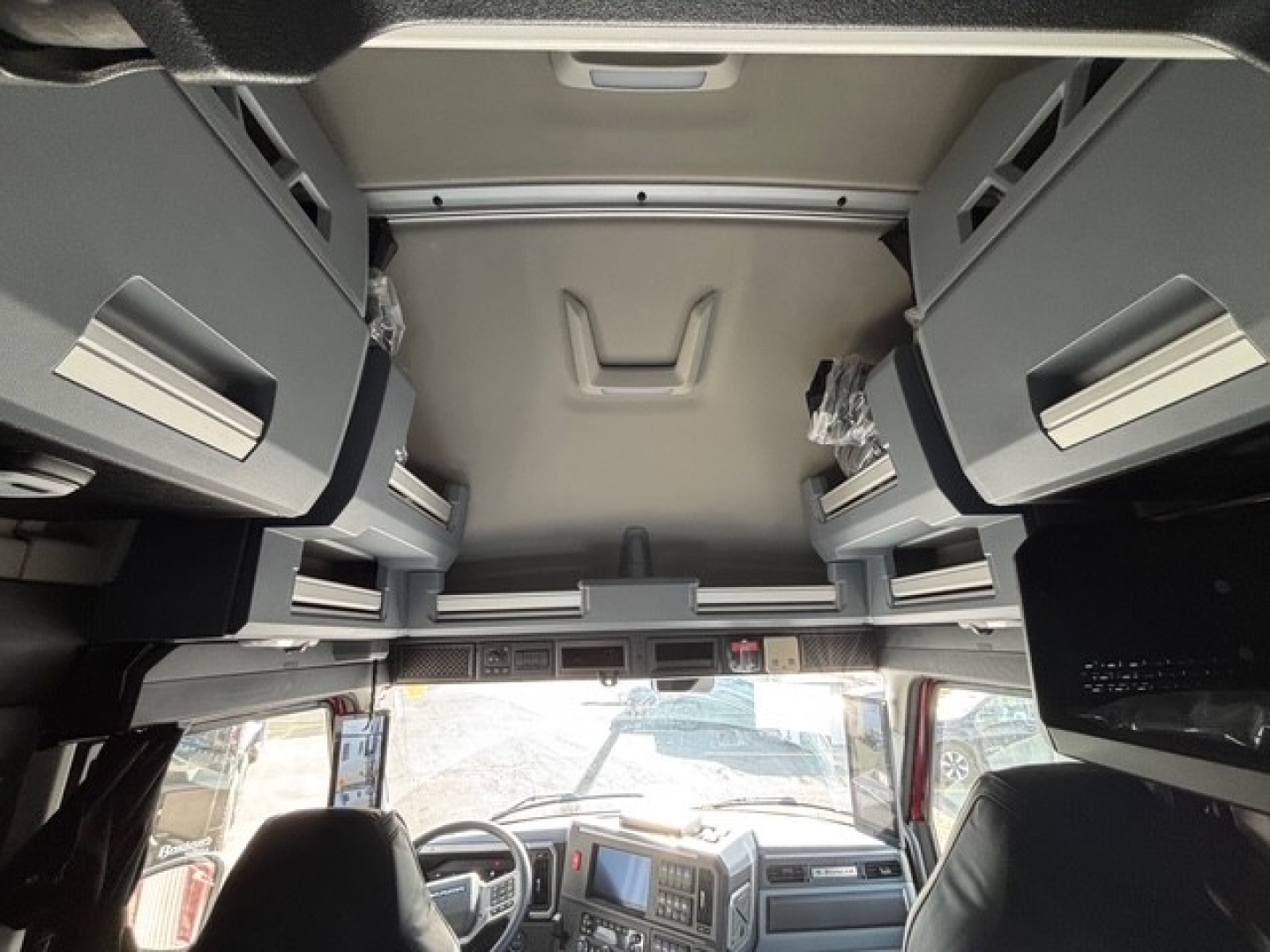Cab interior of a 2026 Mack PR64T76H tractor showing overhead bunk storage with multiple compartments.
