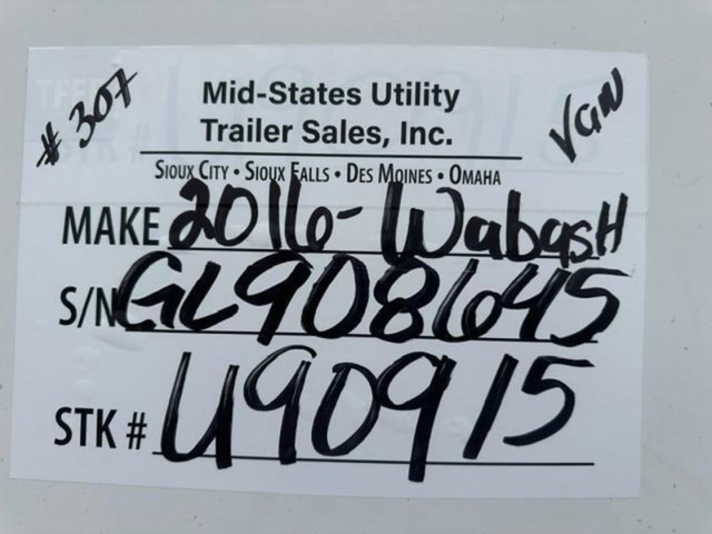 Label on trailer showing Mid-States Utility Trailer Sales, Inc. with handwritten data: Make 20/10-Wabash, S/N GL9086015, STK # U90915.