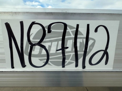 Sign with large handwritten number N87112 on a white background.