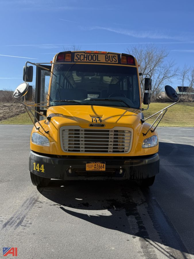 Front view of a yellow 2014 Freightliner B2 school bus showing grille, bumper, headlights, and 'SCHOOL BUS' sign above windshield.