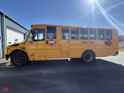 School bus side view showing Central School with stop sign, yellow body, D-Series chassis, blue sky.