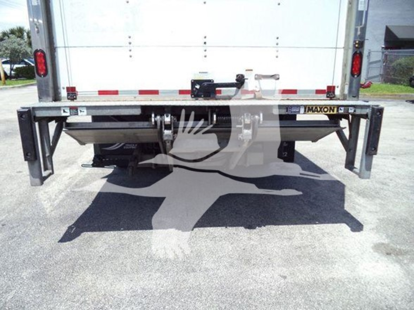 Isuzu NPR box truck rear view showing underride guard and chassis undercarriage