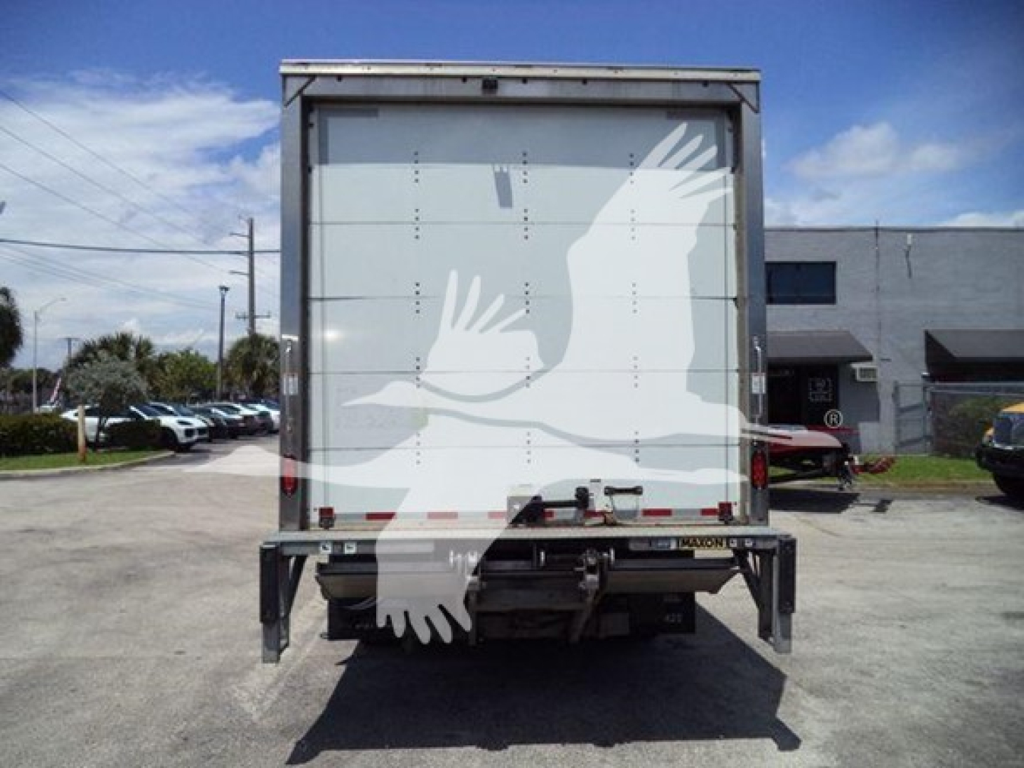Isuzu NPR box truck rear view showing closed cargo doors and bumper with no visible damage.