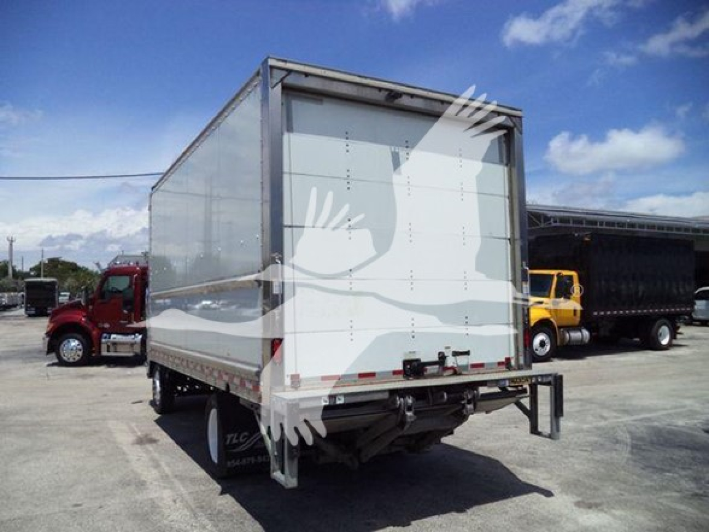 Isuzu NPR box truck rear view showing open cargo area and bumper with taillights.