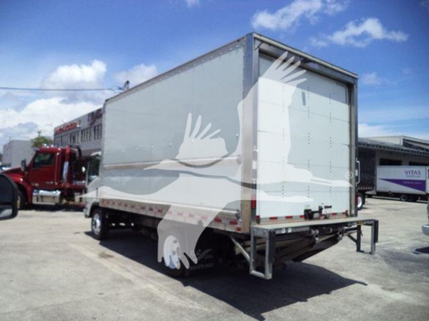 Isuzu NPR box truck rear view showing cargo box and rear doors.