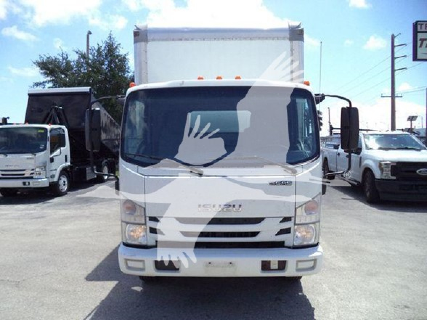 Isuzu NPR box truck front view showing cab and cargo area with Isuzu logo on grille, headlights, and bumper.