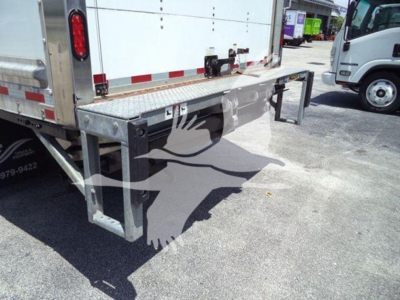 Isuzu NPR box truck rearview showing lower right cargo bumper and loading step with metal frame and reflective tape