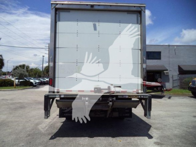 Isuzu NPR box truck rear view showing cargo box doors and bumper with rear lights and hitch area. No legible text visible on the box doors.