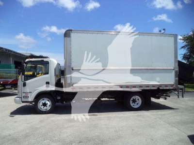 Isuzu NPR box truck side view showing cargo box and cab with VIN sticker obscured by watermark.