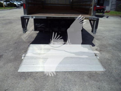 Isuzu NPR box truck rear with aluminum ramp down showing TLC liftgate and back of truck. No legible text other than TLC logo on liftgate.