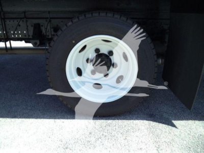 Isuzu NPR truck wheel and tire on left rear with white steel rim. No direct text visible on components.