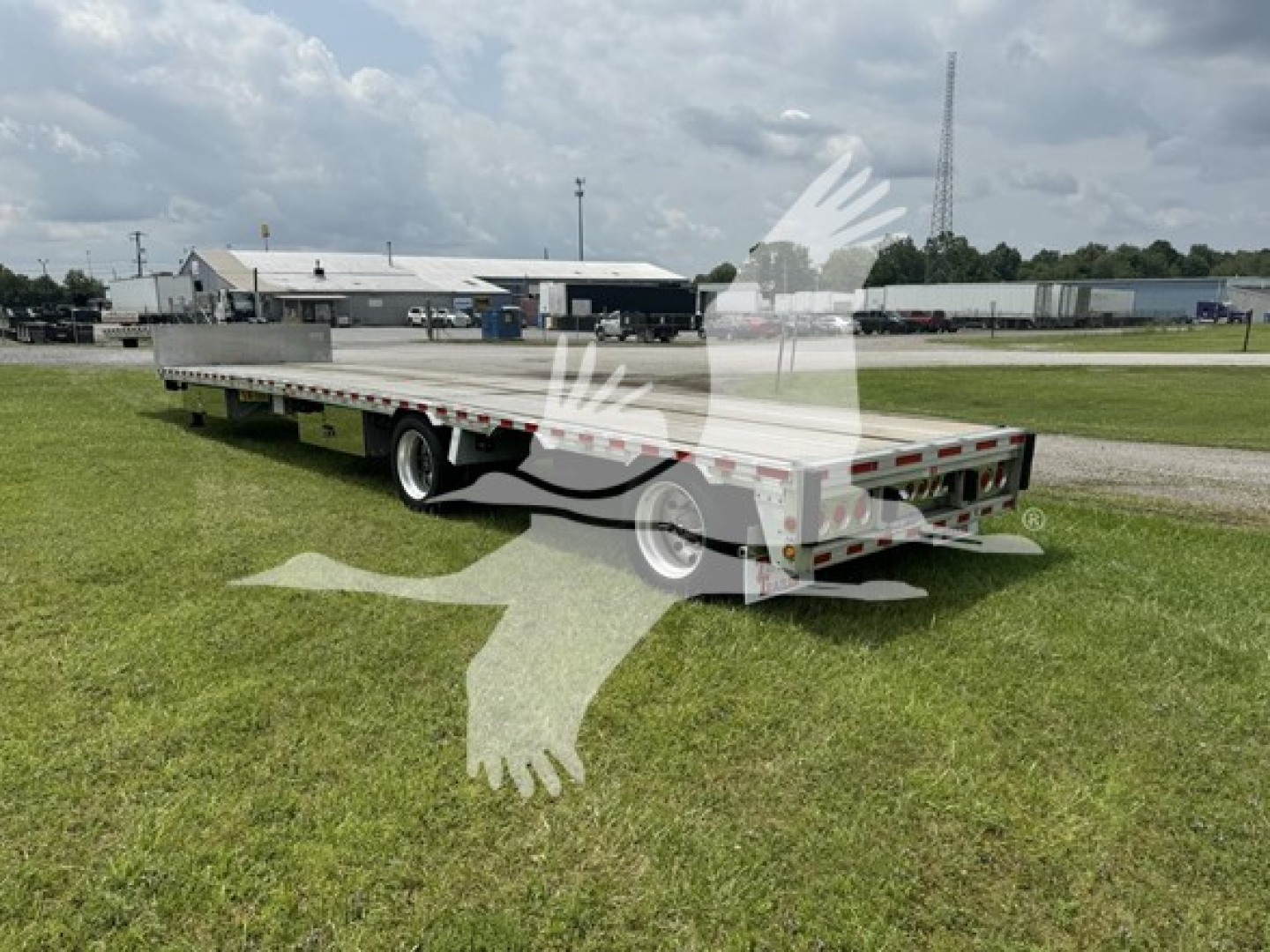 Trailer setup showing a 2019 Reitnouer 48' x 102" drop deck trailer with dropmiser and Ras components. Side rails, tandem axles, rear lighting, and reflective tape visible. 
