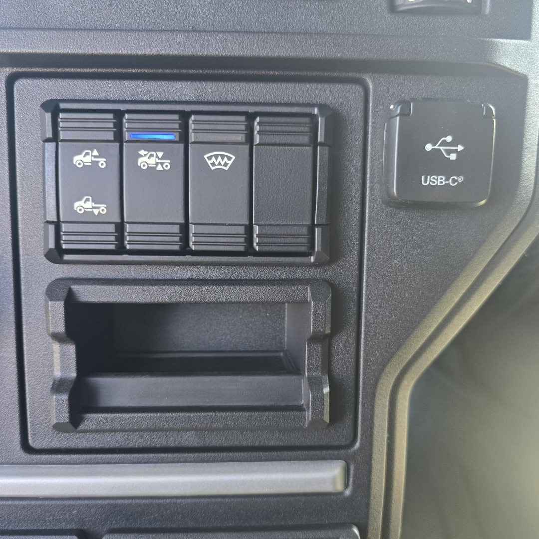 Dashboard switches panel with multiple control buttons and a USB-C port on the Mack PR64T76H cab interior.