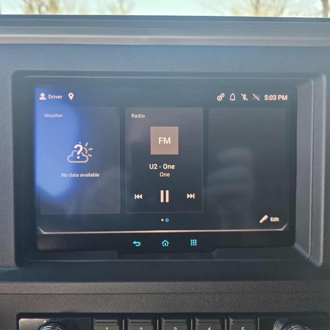Dashboard touchscreen in a Mack PR64T76H truck showing Weather, Radio FM, and Edit options.