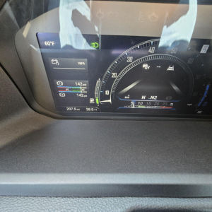 Cab display showing digital gauges in a Mack PR64T76H truck, including temperature 60°F, purple/blue digital panels, tire pressure readouts, and gear indicator with N2 label.