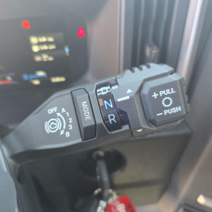 Truck gear selector stalk in cab showing N R and P push-pull control with MODE switch and 12 O 3 B indicators