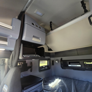 Mack PR64T76H truck cab interior showing overhead bunk area and storage cabinets.