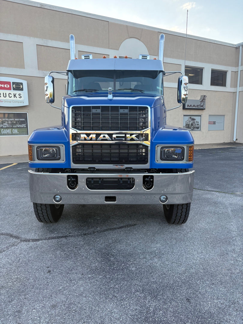 Blue Mack PI64T truck front view showing grille with MACK emblem and chrome bumper.