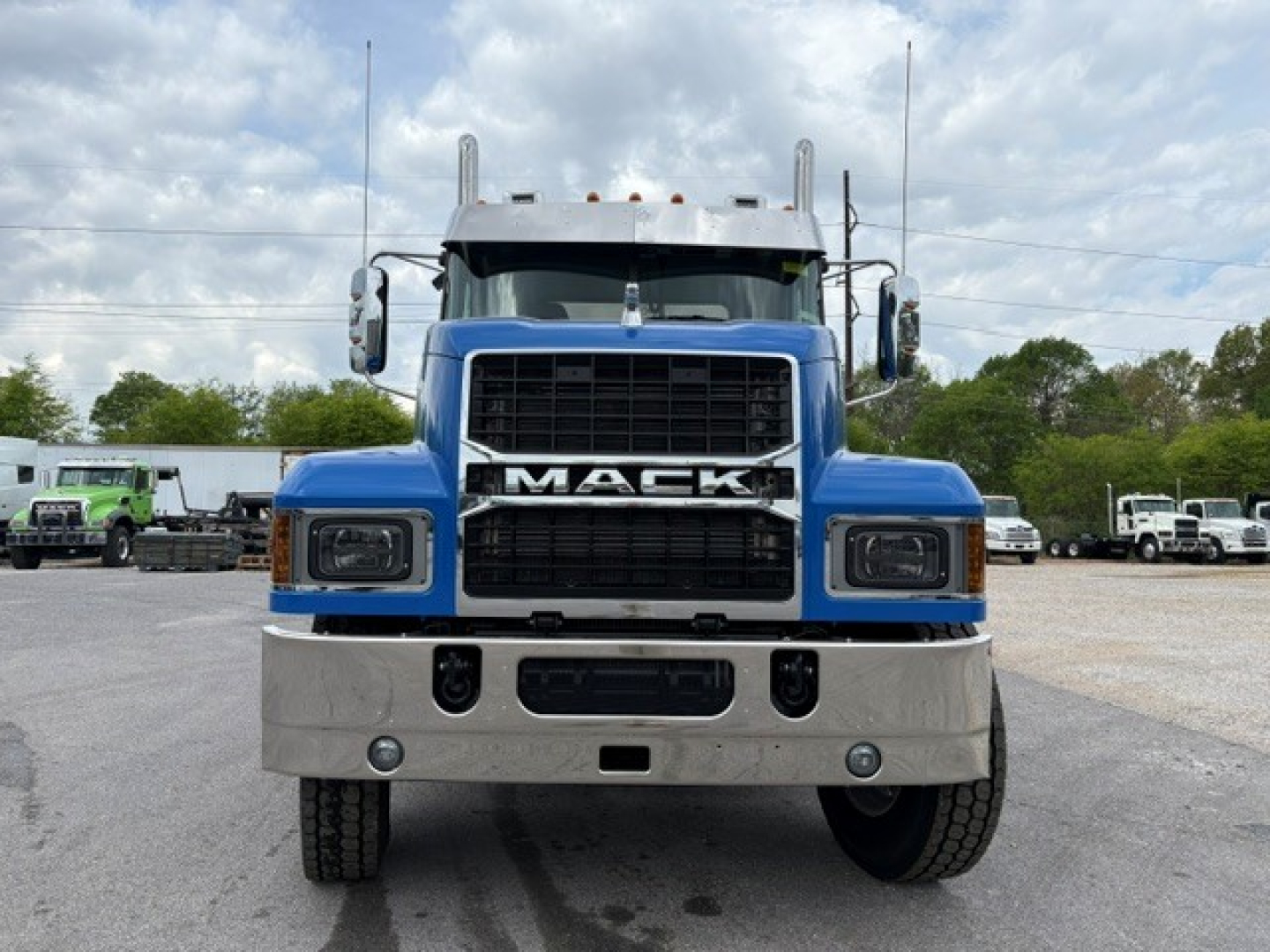 Front view of a blue 2026 Mack PI64T conventional daycab truck showing Mack grille and bumper.