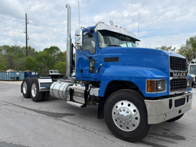 Mack PI64T conventional daycab truck in blue, side view showing fuel tanks and exhaust stack