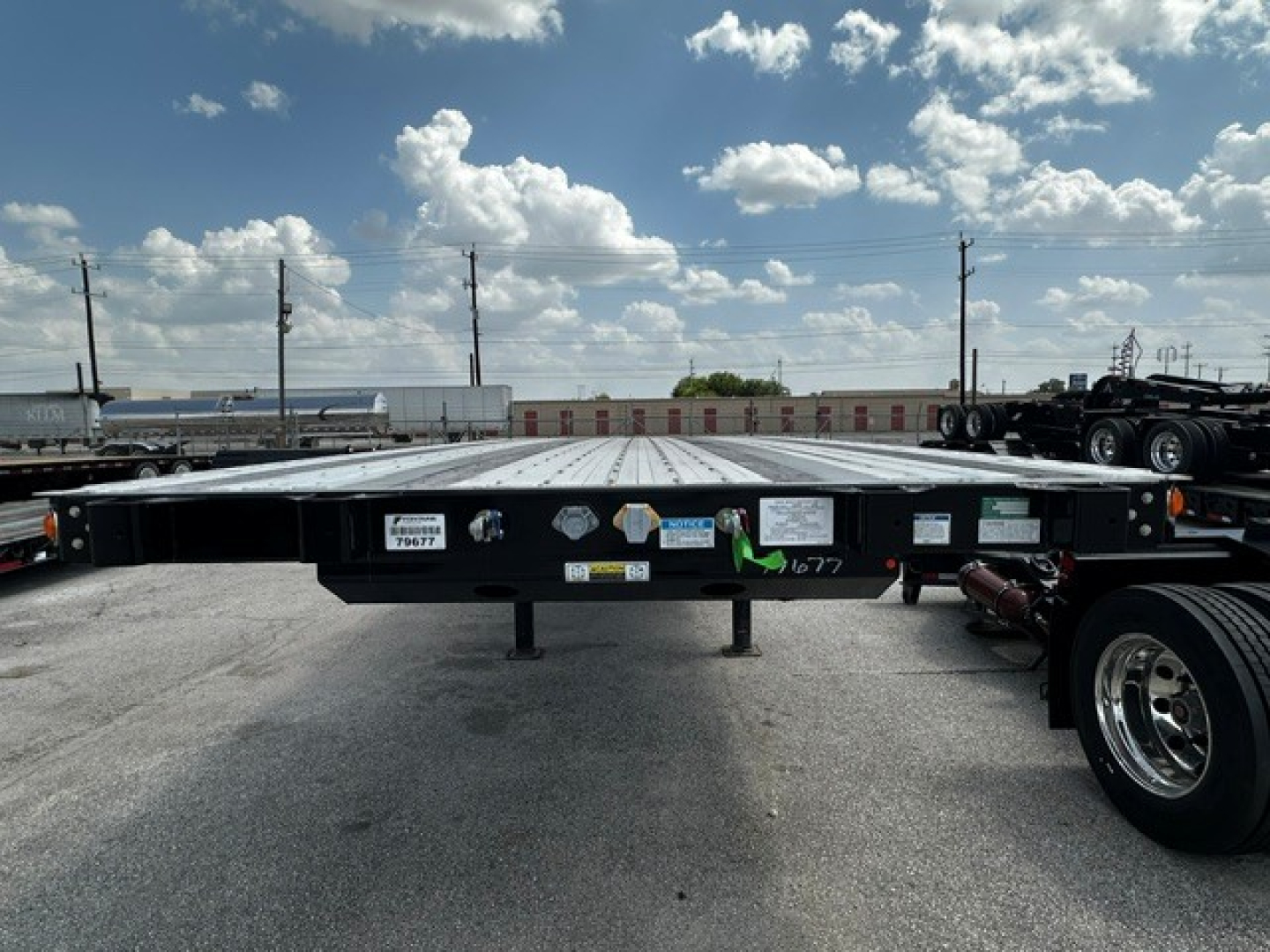 Fontaine 48' combo flatbed trailer viewed head-on with VIN tag and various labels on the front crossmember.