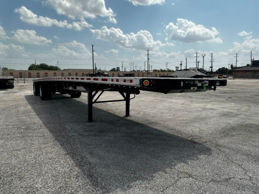 New Fontaine 48' combo flatbed trailer showing low-profile frame and landing gear with reflective tape along the sides.