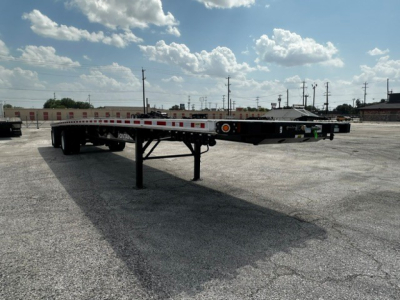 New Fontaine 48' combo flatbed trailer showing low-profile frame and landing gear with reflective tape along the sides.