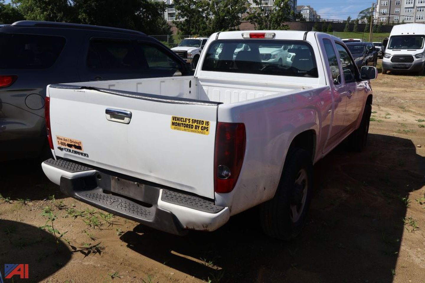 Chevrolet Colorado pickup truck 2010 rear view showing cargo bed with stickers and tailgate in white, 4x4.